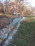local stone open faced drainage ditch
